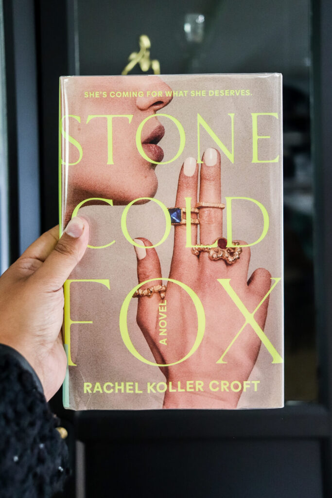 woman's hand holding Stone Cold Fox book by Rachel Koller Croft
