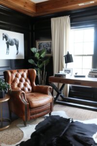 leather tufted armchair in a masculine office with dark walls and a horse painting on the wall