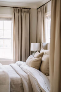bedroom with warm white and brown curtains and bedding